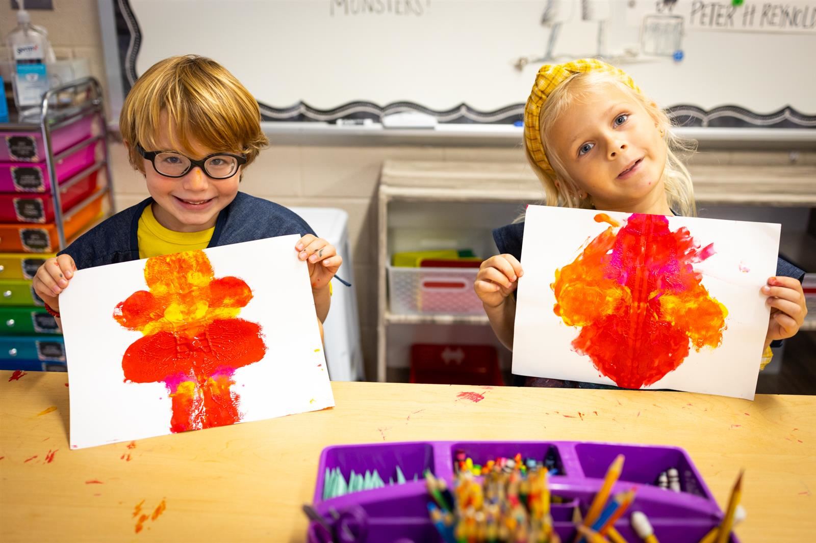 Two students with artwork